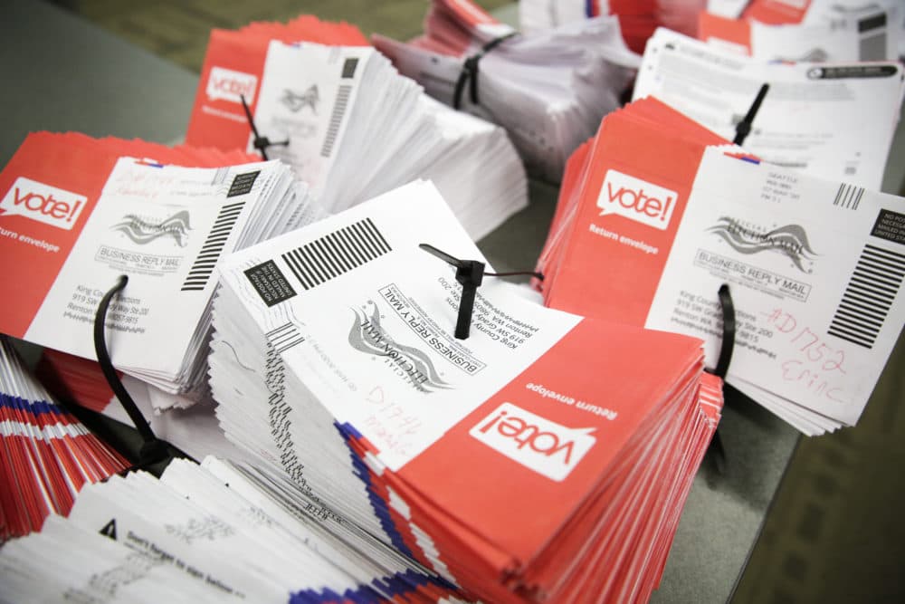 Empty envelopes of opened vote-by-mail ballots for the presidential primary are stacked on a table at King County Elections in Renton, Washington, on March 10, 2020. (Jason Redmond/AFP via Getty Images)