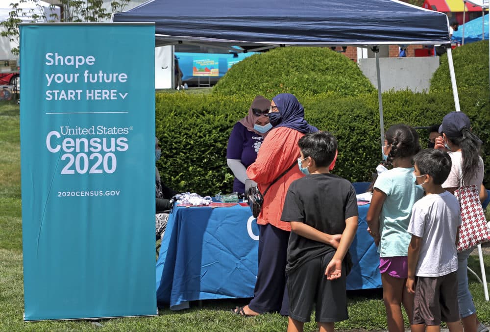 People stand in line at a Census 2020 booth at a farmer's market in Everett, MA on July 24, 2020. Some communities are at risk of being undercounted in the census, because self-response rates so far in the Boston area and other hard-hit communities are only at 50%. (David L. Ryan/The Boston Globe via Getty Images)