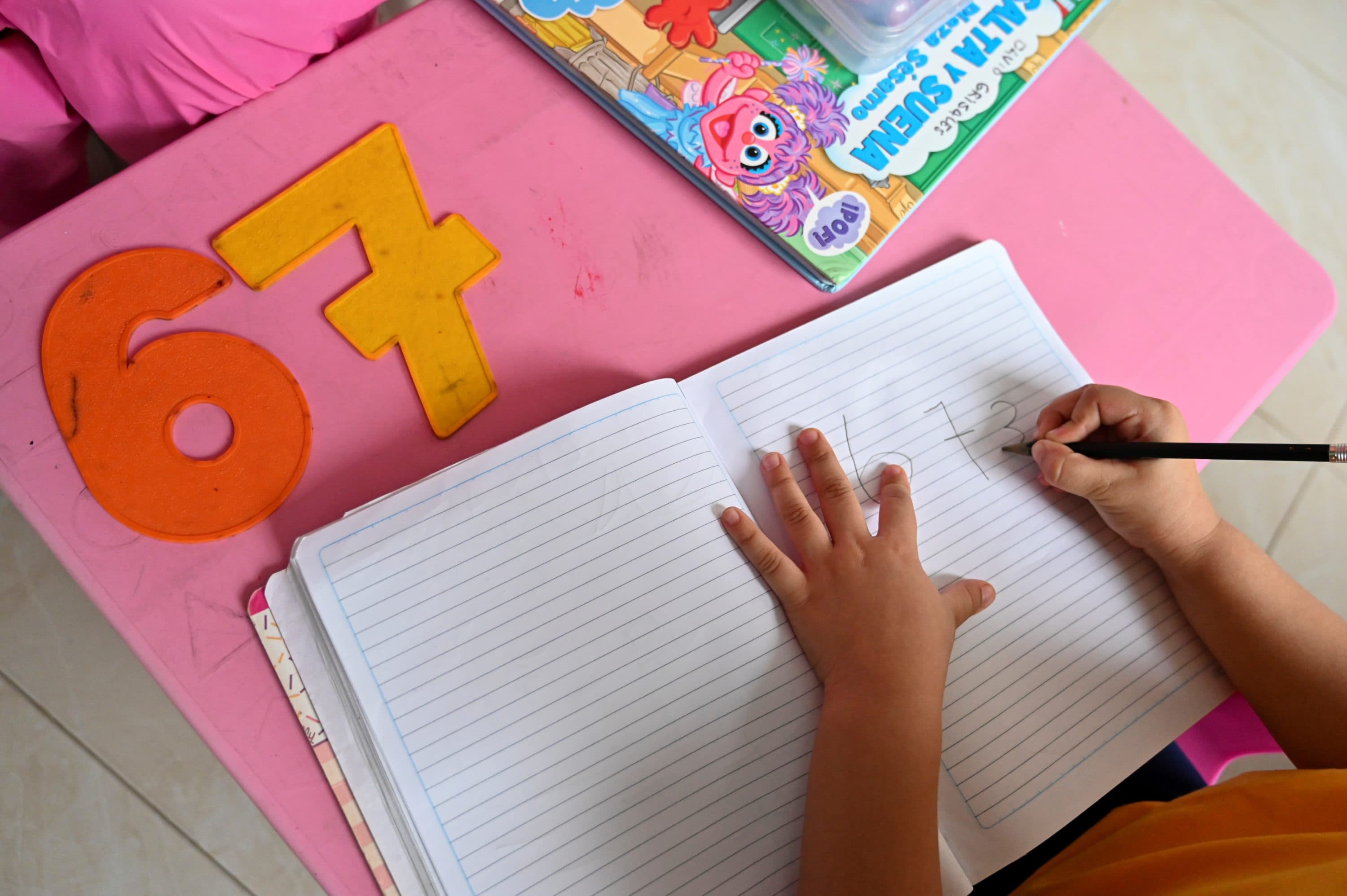 A girl attends a class at home. (Photo by Luis Robayo/AFP via Getty Images)