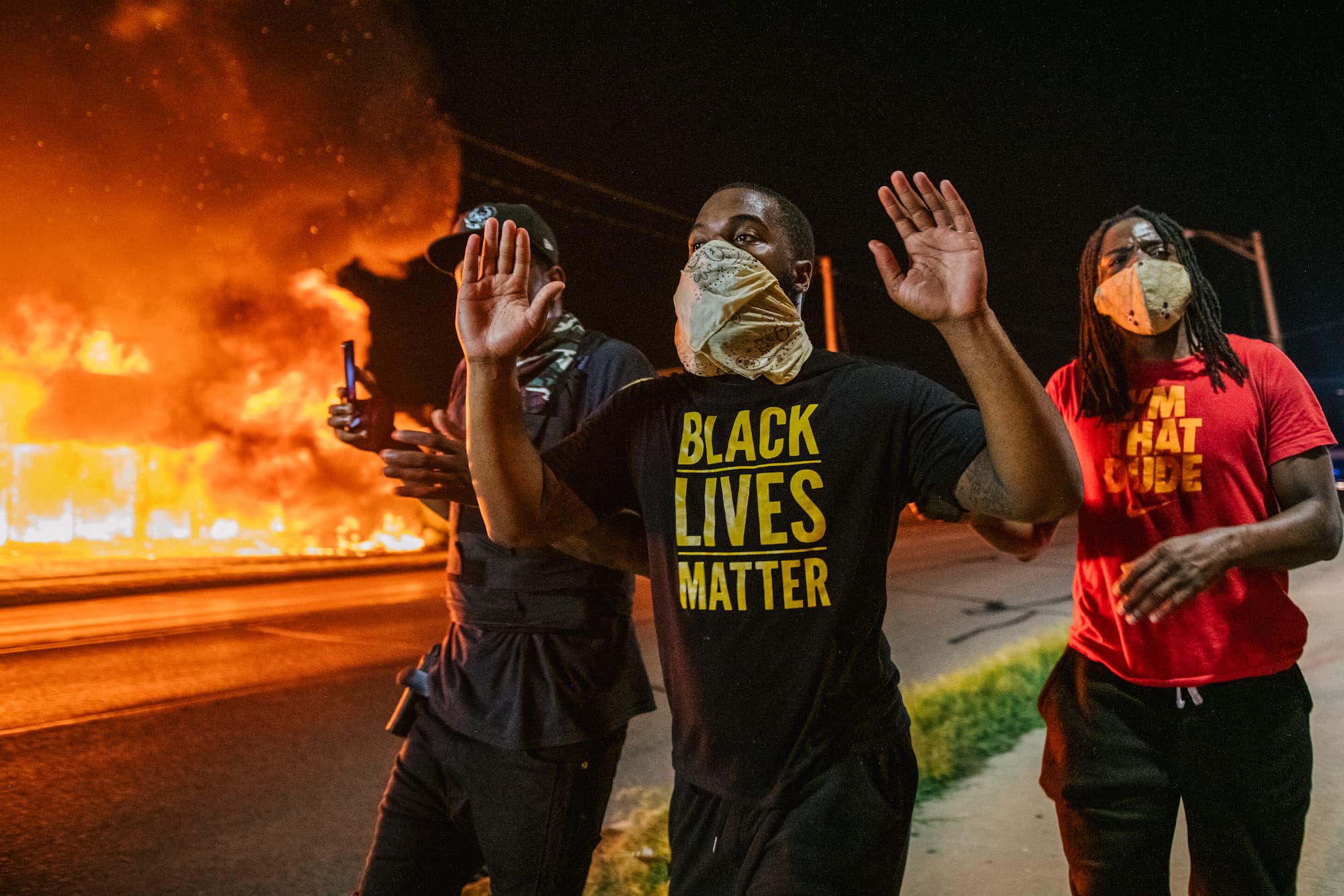 Men walk towards law enforcement with their hands up on August 24, 2020 in Kenosha, Wisconsin. (Photo by Brandon Bell/Getty Images)