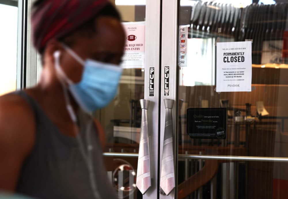 A pedestrian walks by a Jos A. Bank clothing store that is closing on August 03, 2020 in San Francisco, California. (Justin Sullivan/Getty Images)