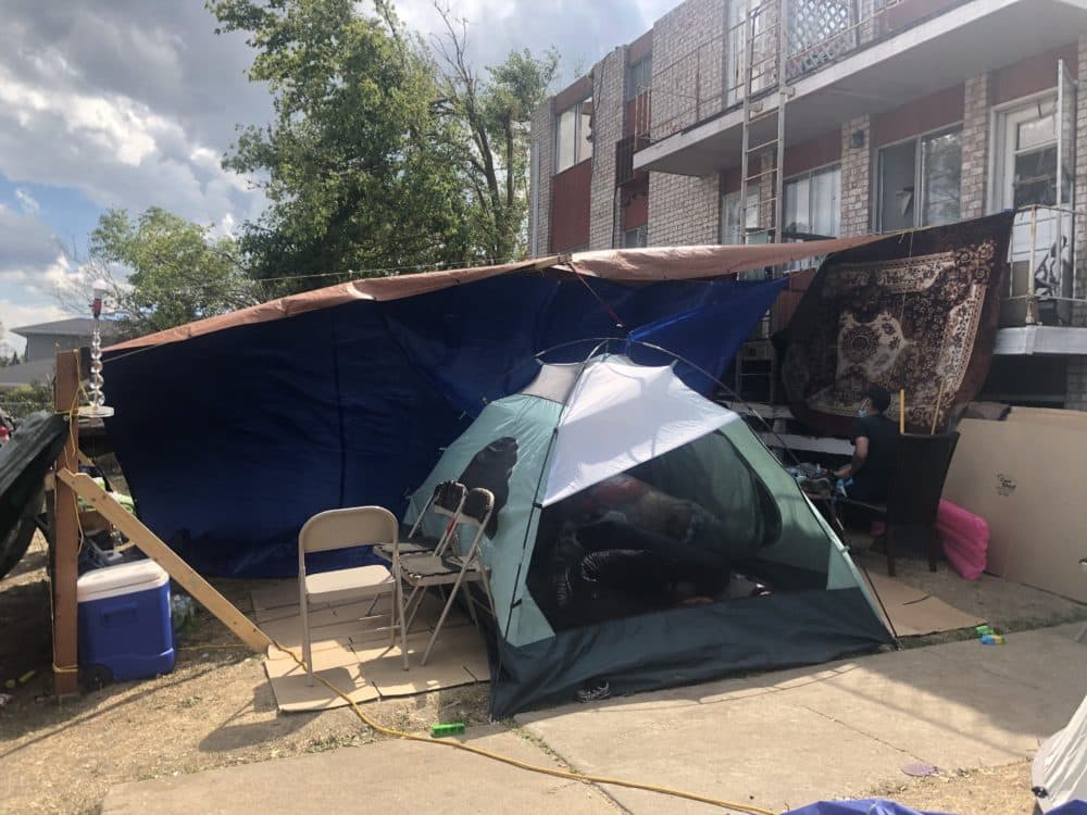 A tent pitched beside various furniture. (Kate Payne/Iowa Public Radio)