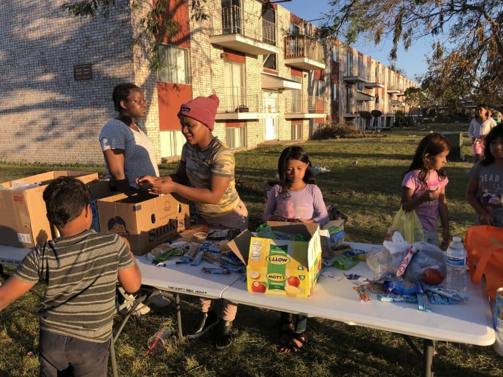 Children surround a table with snacks. (Kate Payne/Iowa Public Radio)