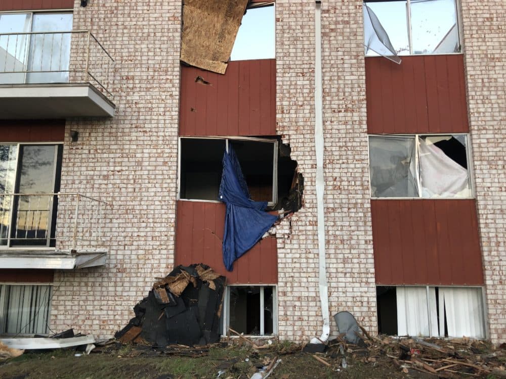 Broken windows in a damaged apartment building. (Kate Payne/Iowa Public Radio)