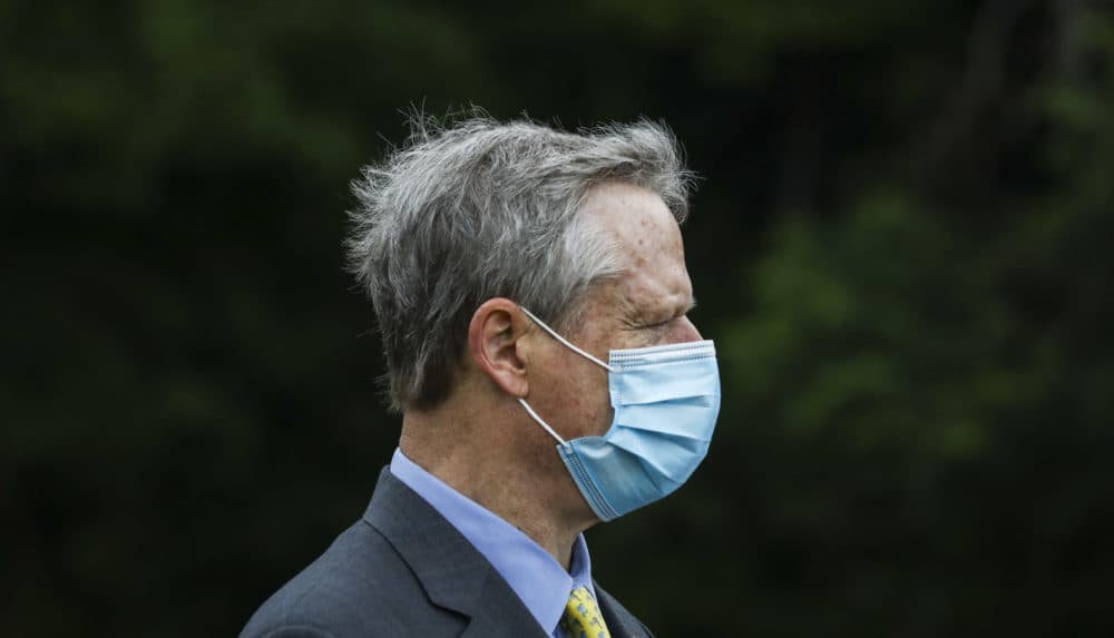 Gov. Charlie Baker wears his face mask during a visit to Assawompset Pond on Friday afternoon. (Erin Clark/The Boston Globe via Pool)