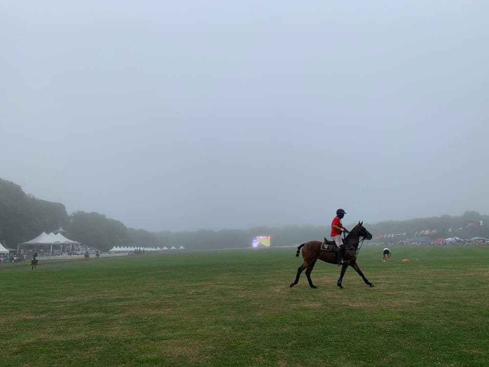 A player takes a final lap as fog covers the polo field at Glen Farm. (Photo by Antonia Ayres-Brown)