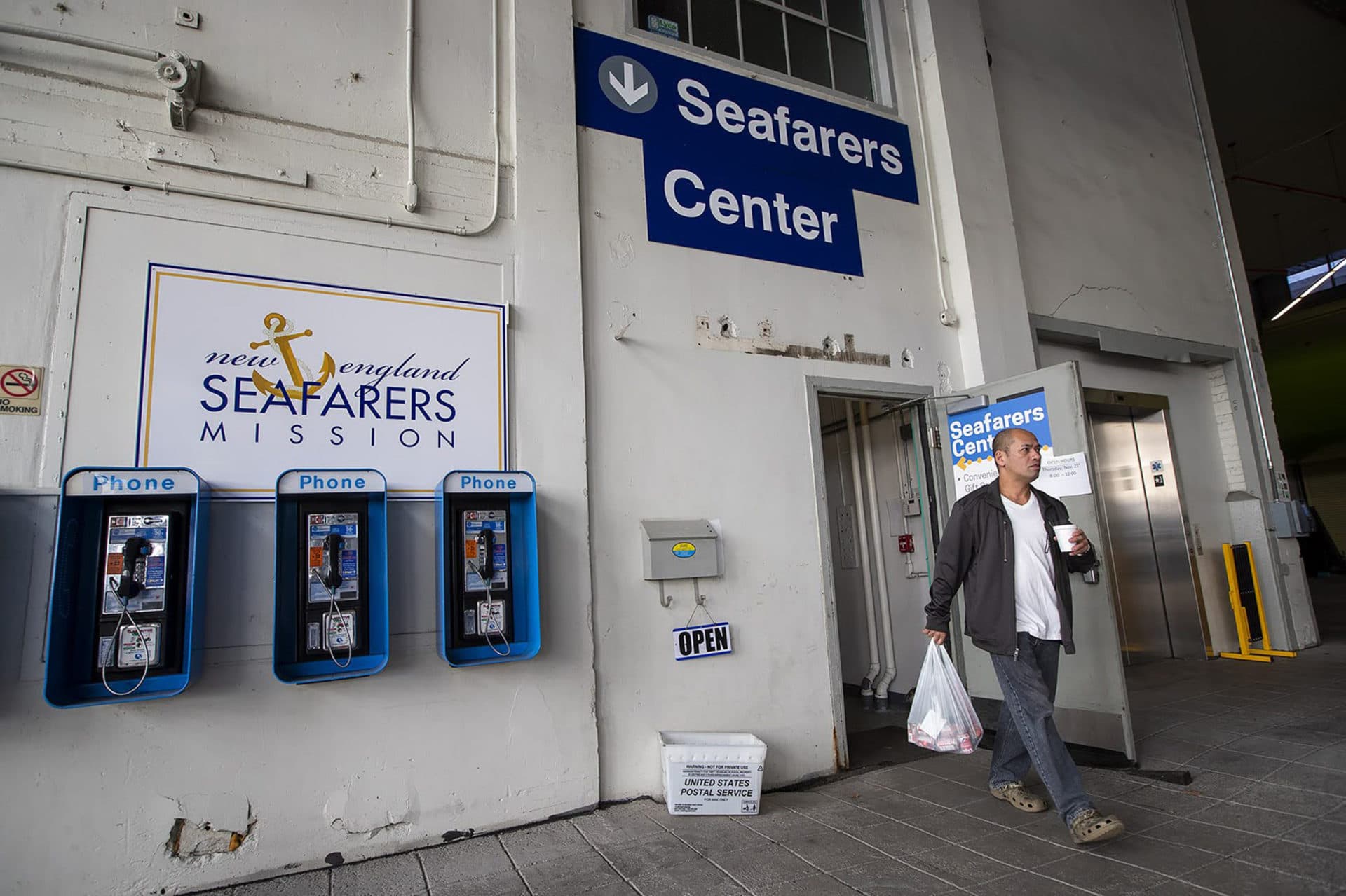 A cruise ship worker walks into the Seafarers Center. (Jesse Costa/WBUR)