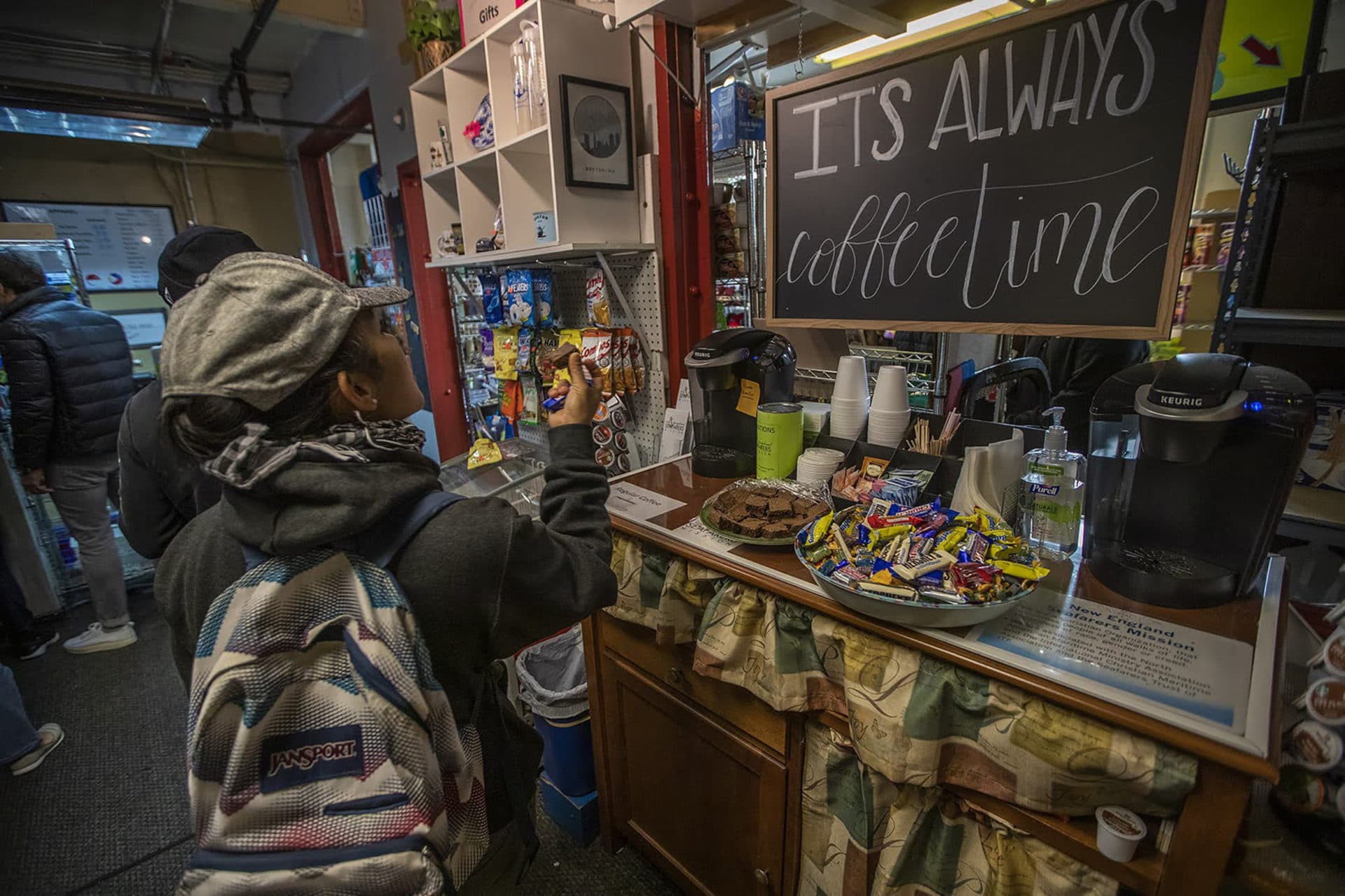 Cruise ship workers grab free coffee and homemade baked goods at the mission's store. (Jesse Costa/WBUR)