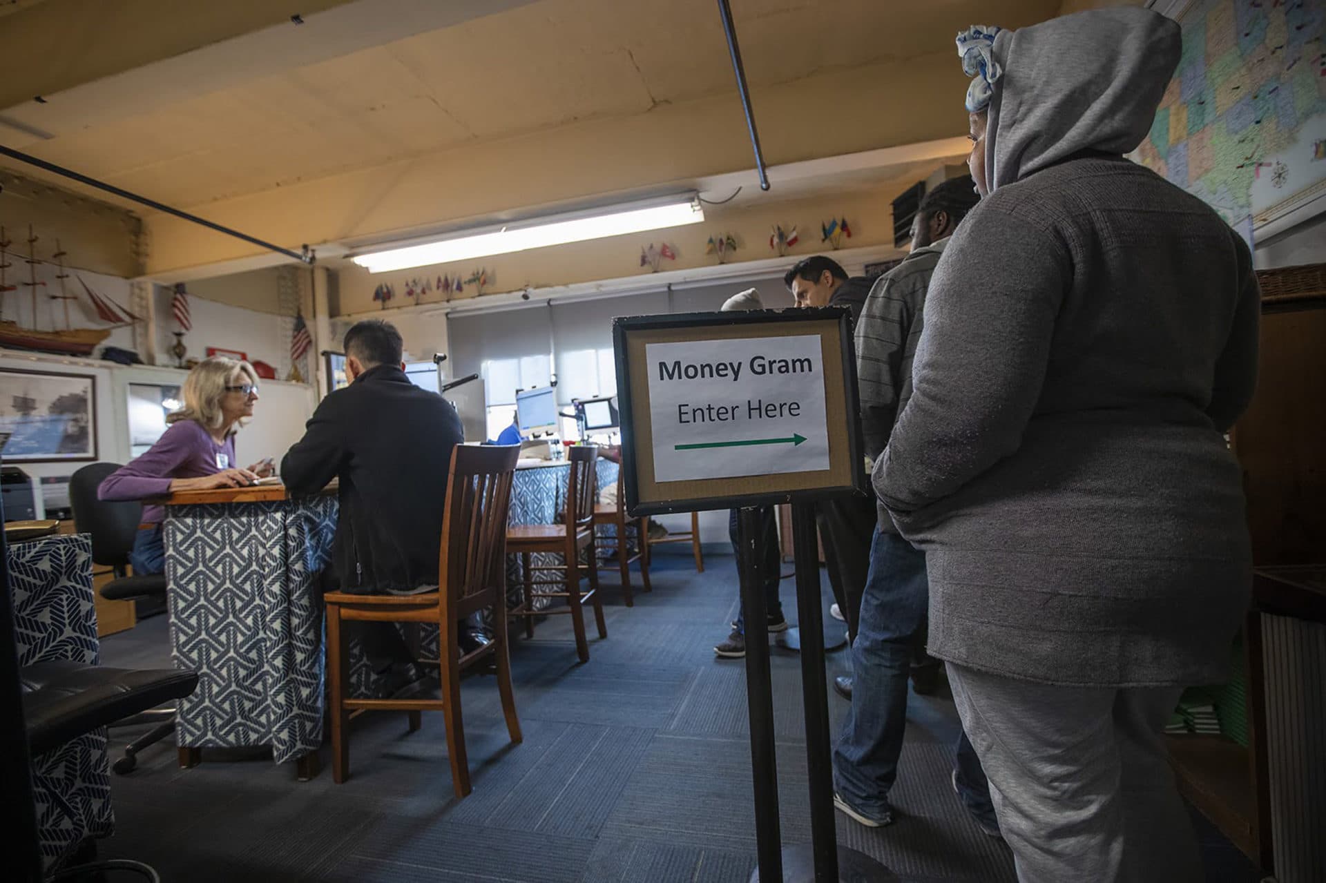 Ship workers send money back home at the MoneyGram terminals on the third floor of the mission. (Jesse Costa/WBUR)