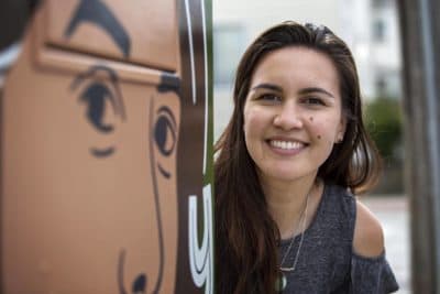 Artist Amanda Beard Garcia at her &quot;You Belong Here&quot; utility box on Harvard Street in South Medford. (Robin Lubbock/WBUR)