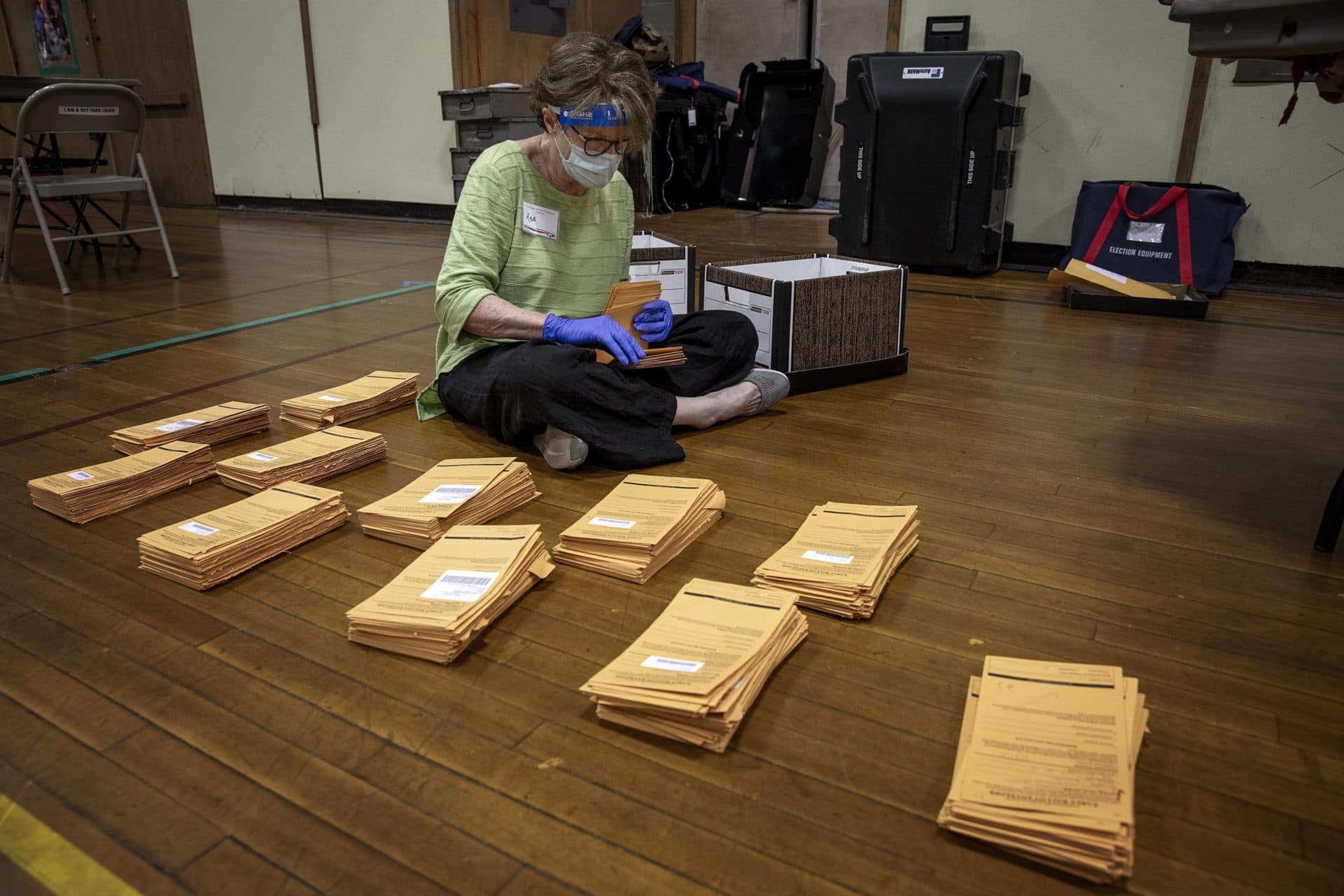 Polling inspector Ann McClenahan counts early voting ballot envelopes at the polling station on Linnaean Street in Cambridge, Mass. (Robin Lubbock/WBUR)