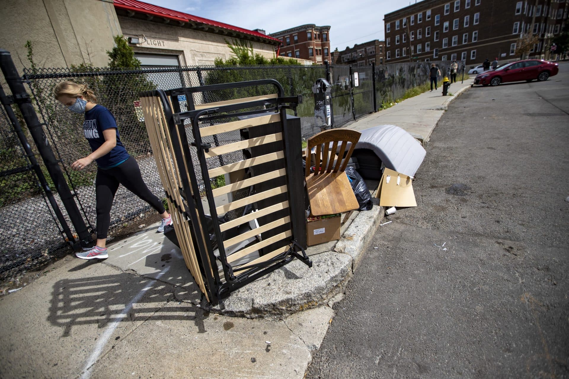 Discarded furniture and trash lay on the sidewalk along Commonwealth Avenue. (Jesse Costa/WBUR)
