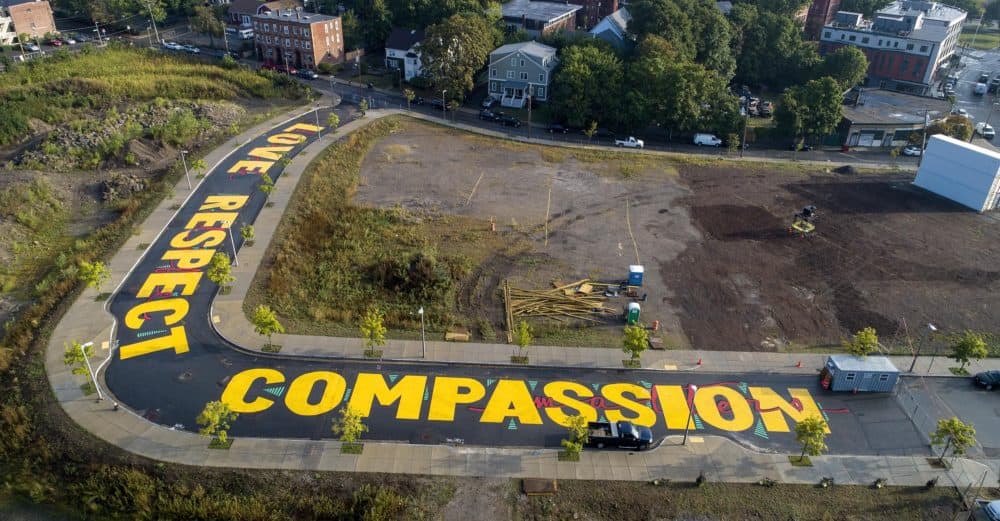 Artist Ricardo &quot;Deme5&quot; Gomez's street painting titled &quot;Rules of Engagement&quot; on Bartlett Station Drive in Roxbury, Mass. (Robin Lubbock/WBUR)
