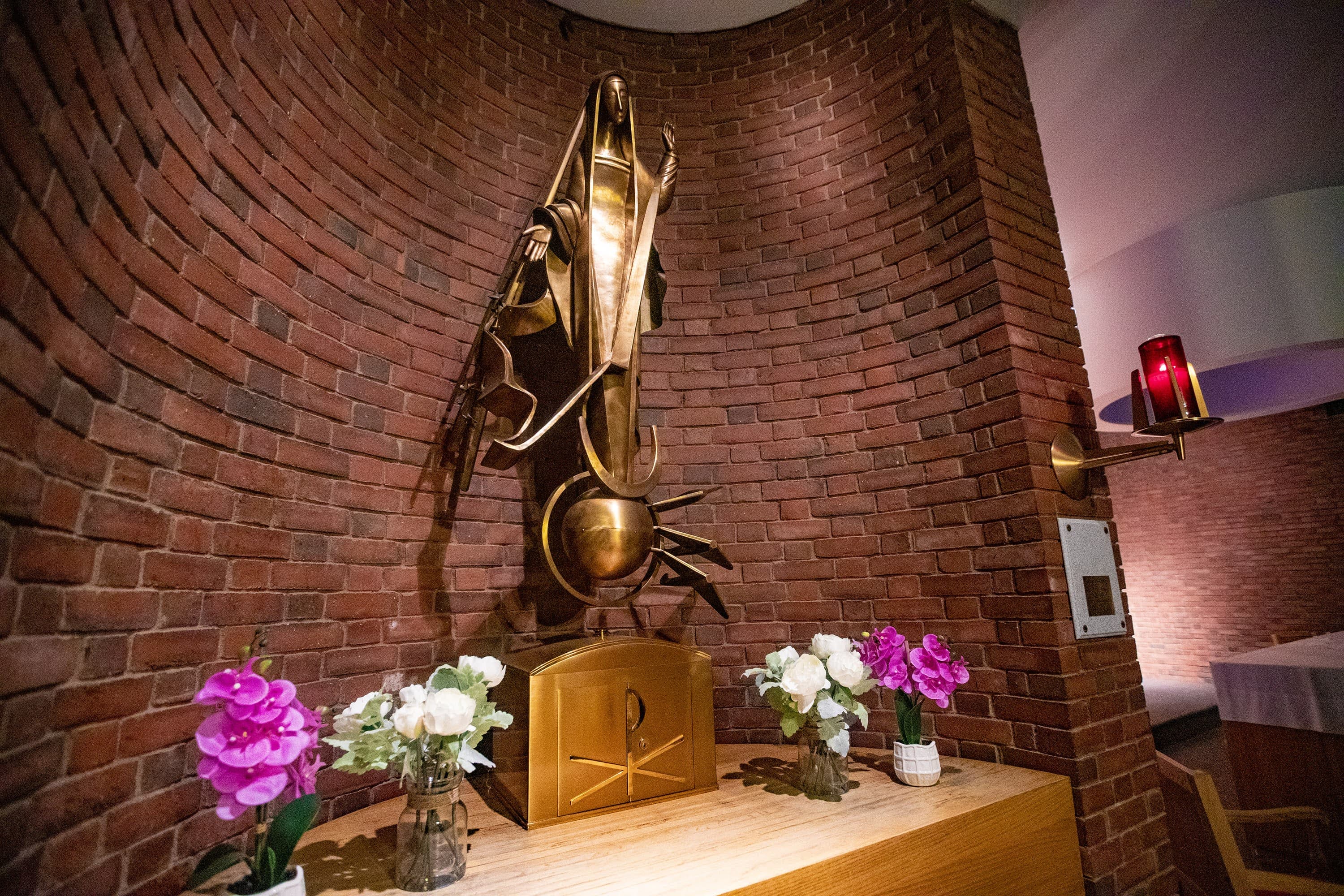 A statue of the Virgin Mary standing atop a globe with planes flying around it at the Our Lady of the Airways chapel at Logan Airport. (Jesse Costa/WBUR)