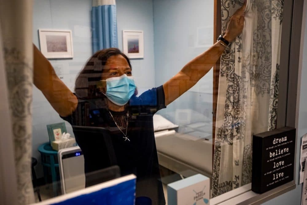 Judy Duarte draws the curtains in the "medical waiting room," or isolation area. (Jesse Costa/WBUR)