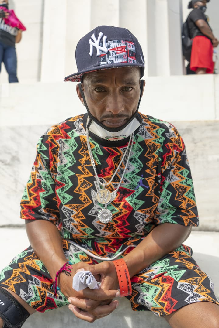 Korey Wise, the oldest of the group who became known as the &quot;Central Park Five,&quot; waits for Congresswoman Ayanna Pressley to speak. (OJ Slaughter for WBUR)