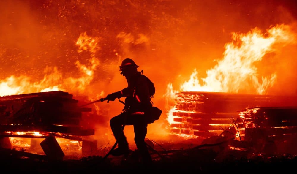 A firefighter douses flames as they push towards homes during the Creek fire in the Cascadel Woods area of unincorporated Madera County, California on September 7, 2020.(JOSH EDELSON/AFP via Getty Images)