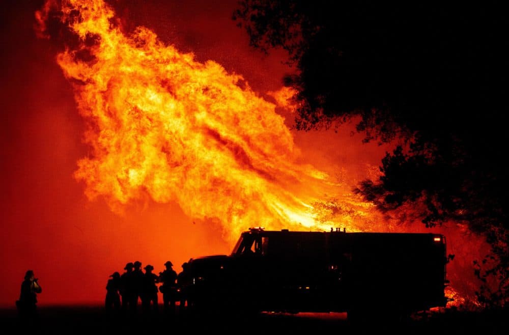 Butte county firefighters watch as flames tower over their truck during the Bear fire in Oroville, California on September 9, 2020. (JOSH EDELSON/AFP via Getty Images)