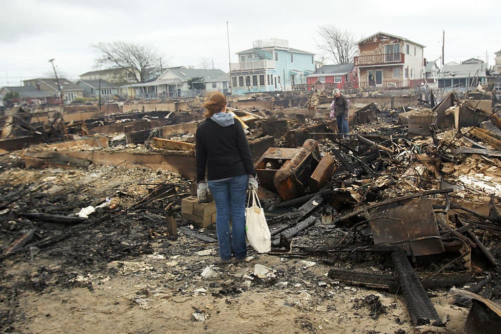 People look through the remains of homes destroyed during Hurricane Sandy October 30, 2012 in the Breezy Point neighborhood of the Queens borough of New York City. (Spencer Platt/Getty Images)