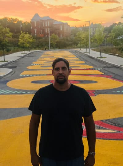 Artist Ricardo “Deme5” Gomez in front of his project &quot;Rules of Engagement.&quot; (Courtesy Mushen Kieta)