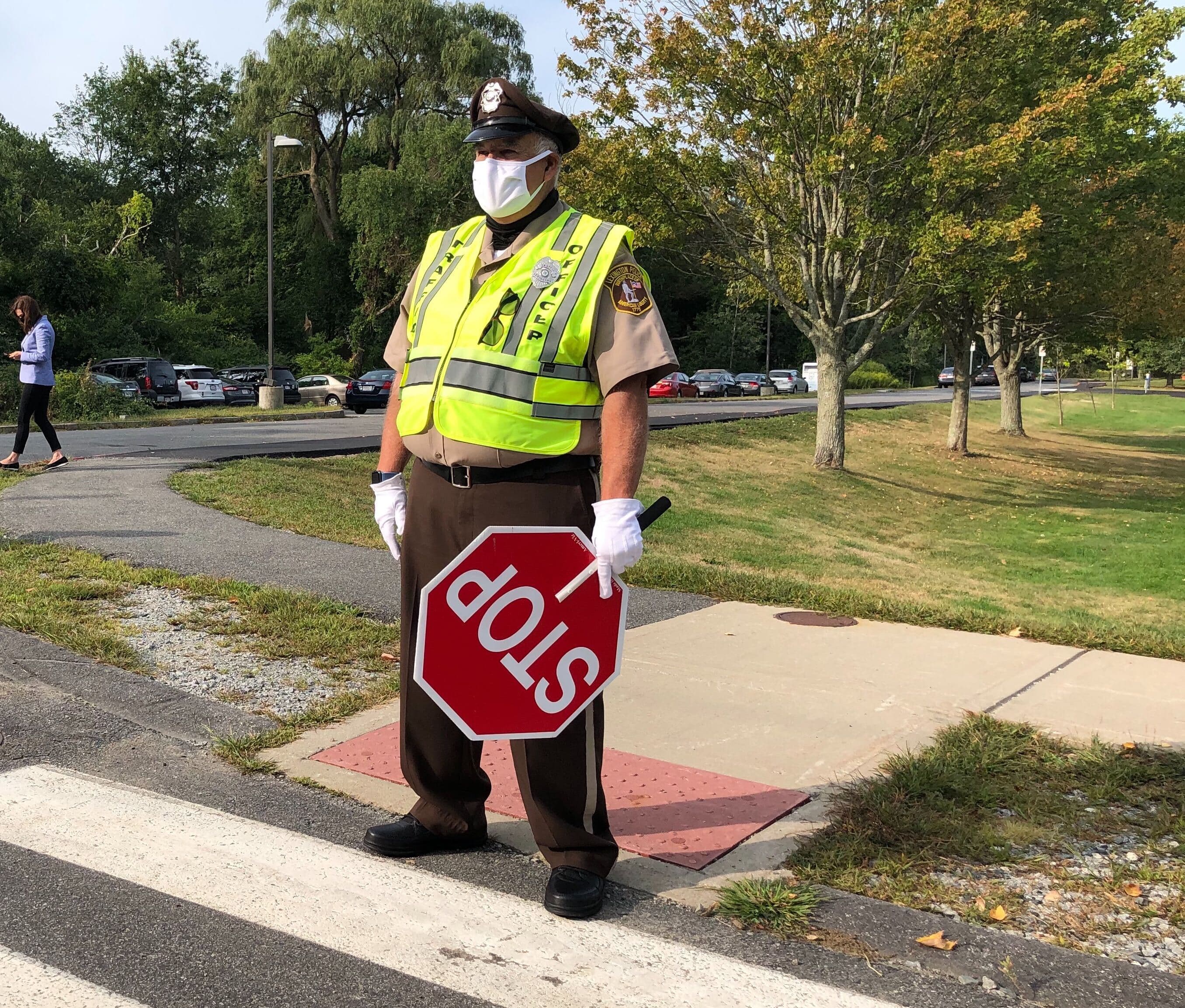 Crossing Guard David Hadley helps kindergarten students and their families across Philip Road.