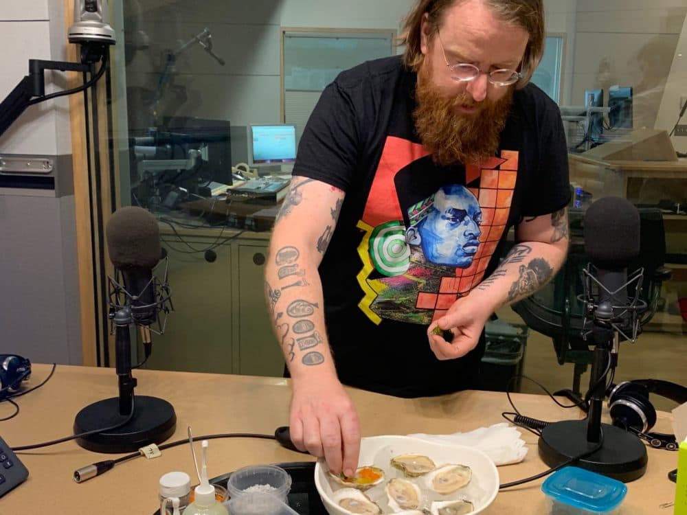 Michelin-star chef and author JP McMahon prepares oysters at WBUR's studios. (Zoe Mitchell/WBUR)