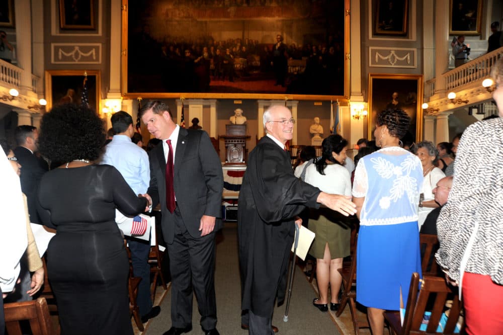 Mayor Martin Walsh and U.S. District Judge Nathaniel Gorton congratulate newly sworn in residents during a naturalization ceremony at Faneuil Hall July 10, 2014. (Don Harney/City of Boston)