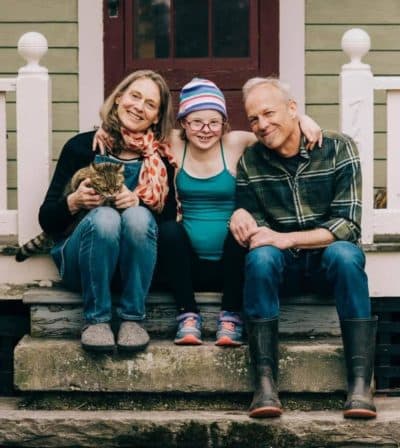 With school still online in Amherst, Mass., parents Katie Shults and Ted White continue to play a large part in their daughter Eve's online education. Eve, who has Down syndrome, just started 8th grade. (Courtesy Isabella Dellolio/isabelladellolio.com via NEPM)