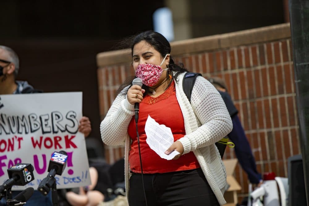 East Boston resident Maria Carolina Ticona speaks during a rally at City Hall, calling for an increase in the number of affordable units for a proposed development at Suffolk Downs. (Jesse Costa/WBUR)