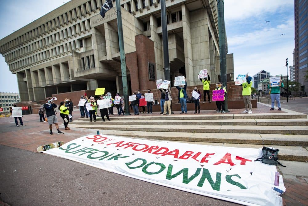 Affordable housing advocates gathered for a rally in front of City Hall on Tuesday ahead of the BPDA's vote on the Suffolk Downs redevelopment. (Jesse Costa/WBUR)