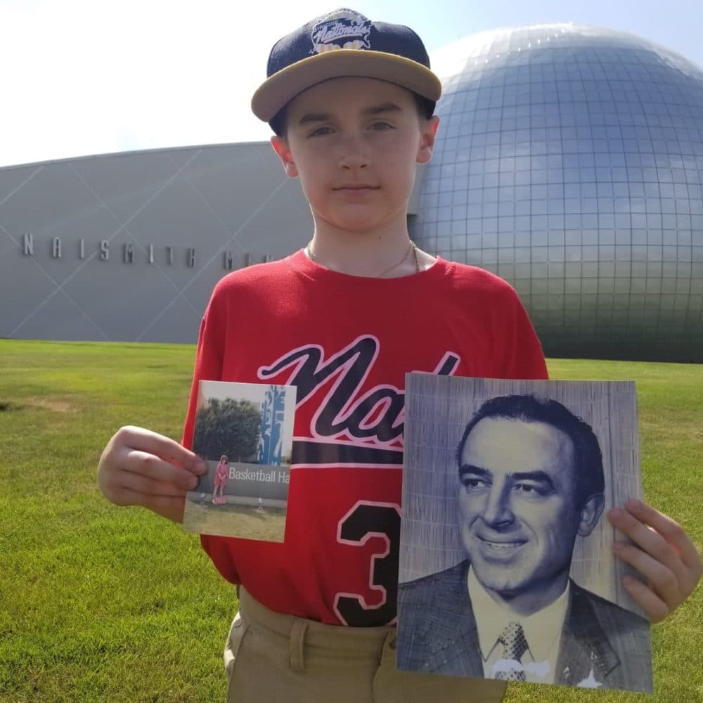 Christian Figueroa's son, Christian, stands on the lawn of the Naismith Hall of Fame holding a photo of Leo Ferris. (Courtesy Christian Figueroa)
