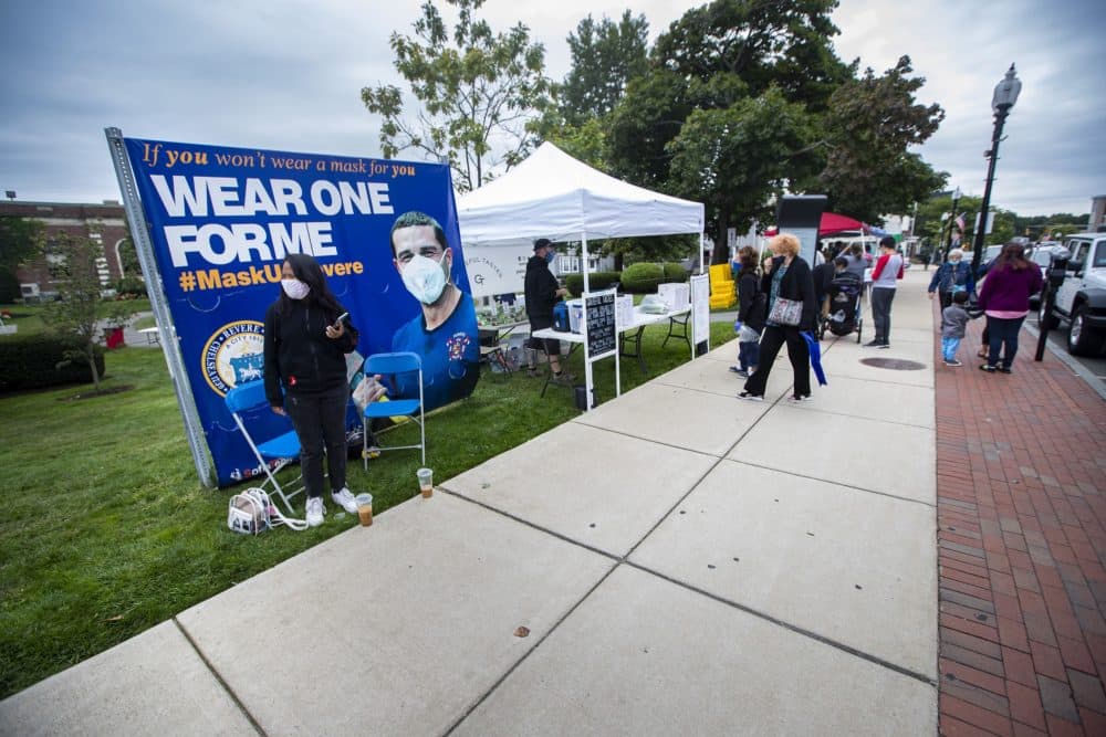 A banner set up by the city of Revere informing residents to mask up in front of the American Legion on Broadway. (Jesse Costa/WBUR)