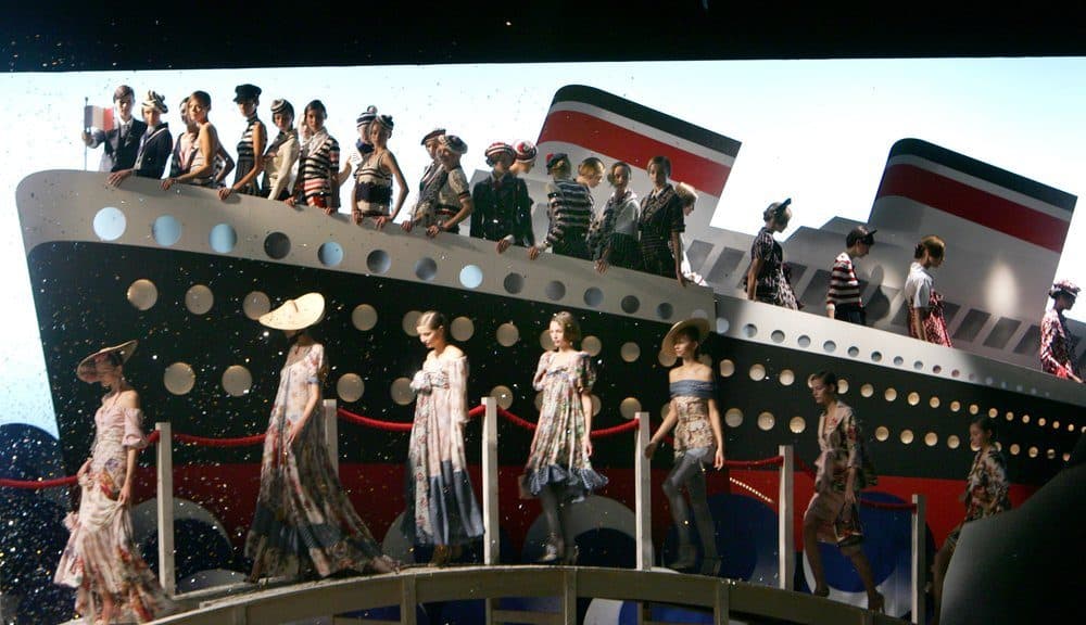In this Saturday Oct. 8, 2005 file photo, models pose at the final of the presentation of the Kenzo Spring/Summer ready to wear 2006 collection by Italian fashion designer Antonio Marras in Paris. Fashion designer Kenzo Takada dies from COVID-19 complications at age 81 near Paris, spokeswoman and reports said Sunday Oct. 4, 2020. (Remy de la Mauviniere/AP)