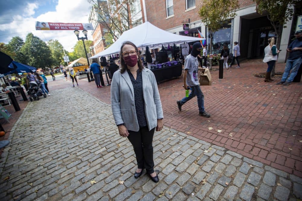 Kate Fox, executive director at Destination Salem, stands on Essex Street in Salem, which is normally filled with a river of people in October for the high Halloween holiday season. (Jesse Costa/WBUR)