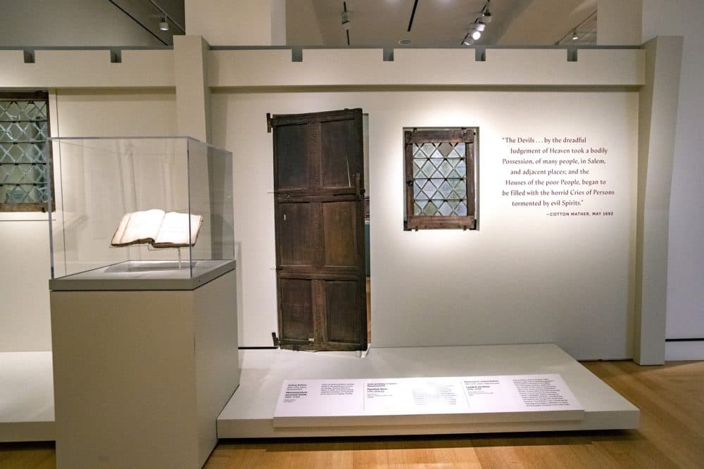 Joshua Buffum's account book, a 17th century paneled door, and a leaded window. (Jesse Costa/WBUR)