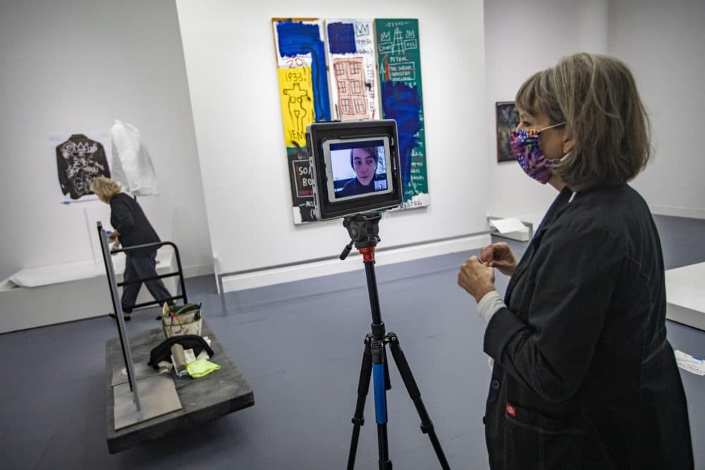 Head registrar Jill Kennedy-Kernohan on a remote Zoom check-in call with the exhibit's project manager Valentine Lescar assuring pieces in the &quot;Writing the Future: Basquiat and the Hip-Hop Generation&quot; exhibit have been properly installed. (Jesse Costa/WBUR)