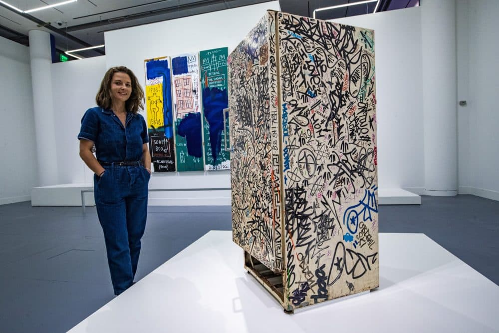 Liz Munsell, curator of contemporary art at the MFA, stands beside &quot;Untitled (Fun Fridge)&quot; by Jean‑Michel Basquiat. (Jesse Costa/WBUR)