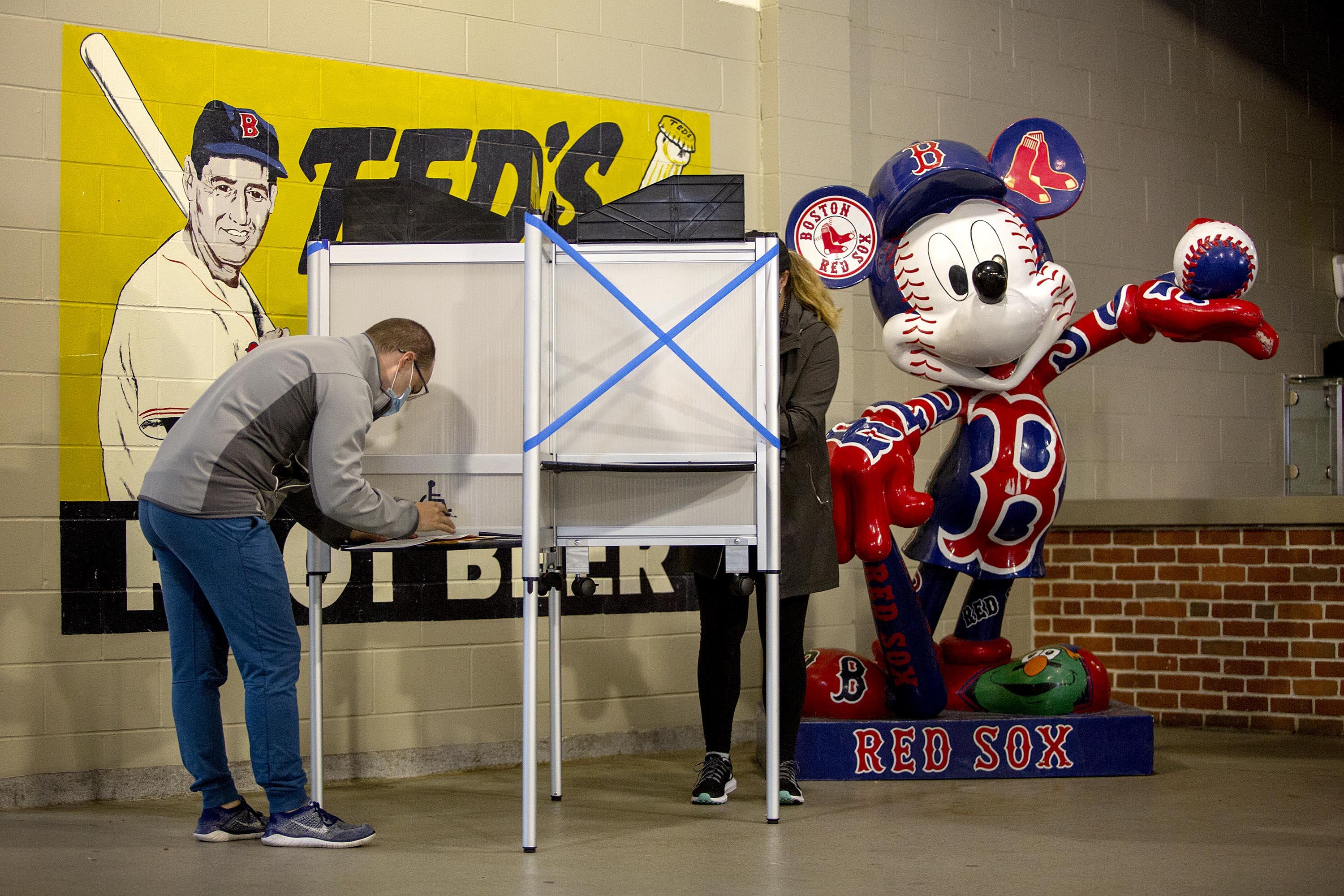 Ted and Mickey oversee a socially distanced voting booth, as voting gets under way at Fenway Park. (Robin Lubbock/WBUR)