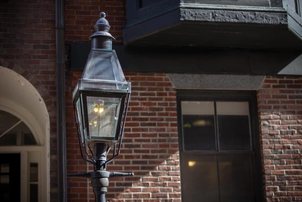 A gas lamp burning on Temple Street in the middle of the day. The lamps remain lit 24 hours a day. (Robin Lubbock/WBUR)