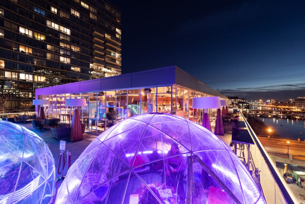 Diners enjoying a meal inside igloos at Boston's Envoy Hotel. (Courtesy)