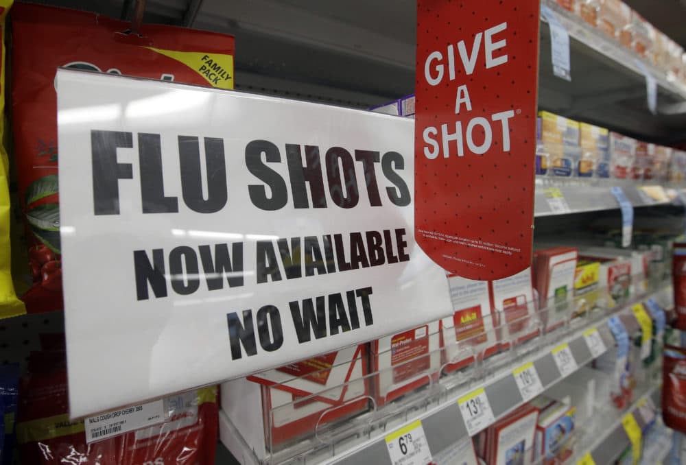 In this Sept. 16, 2014 file photo, a sign telling customers that they can get a flu shot in a Walgreen store is seen in Indianapolis. (Darron Cummings, AP, File)