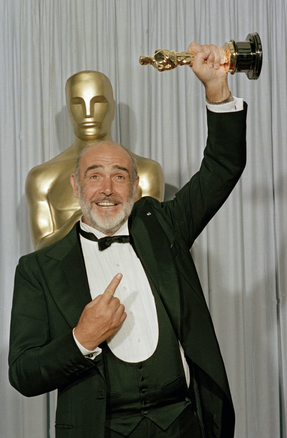 In this file photo dated April 11, 1988, Sean Connery holds up his best supporting actor Oscar for &quot;The Untouchables&quot; at the 60th annual Academy Awards in Los Angeles, Ca., USA. Scottish actor Sean Connery, considered by many to have been the best James Bond, has died aged 90, according to an announcement from his family. (Lennox McLendon/AP)
