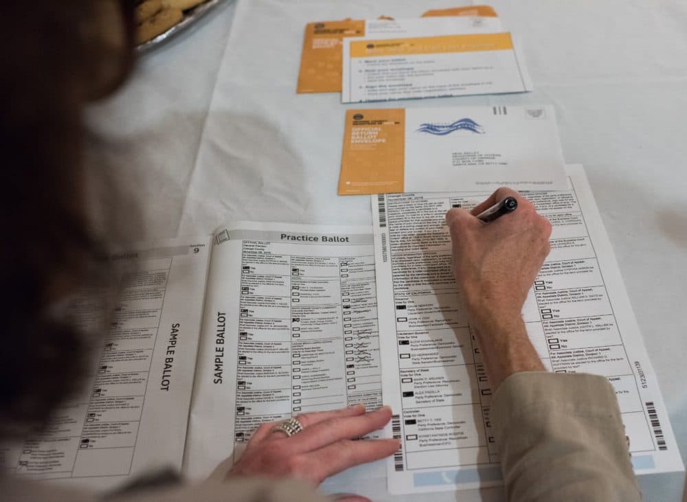 Voter Becky Visconti completes her mail-in ballot at a Ballot Party at a private residence in Laguna Niguel, California, on Oct. 24, 2018. (Robyn Beck/AFP via Getty Images)