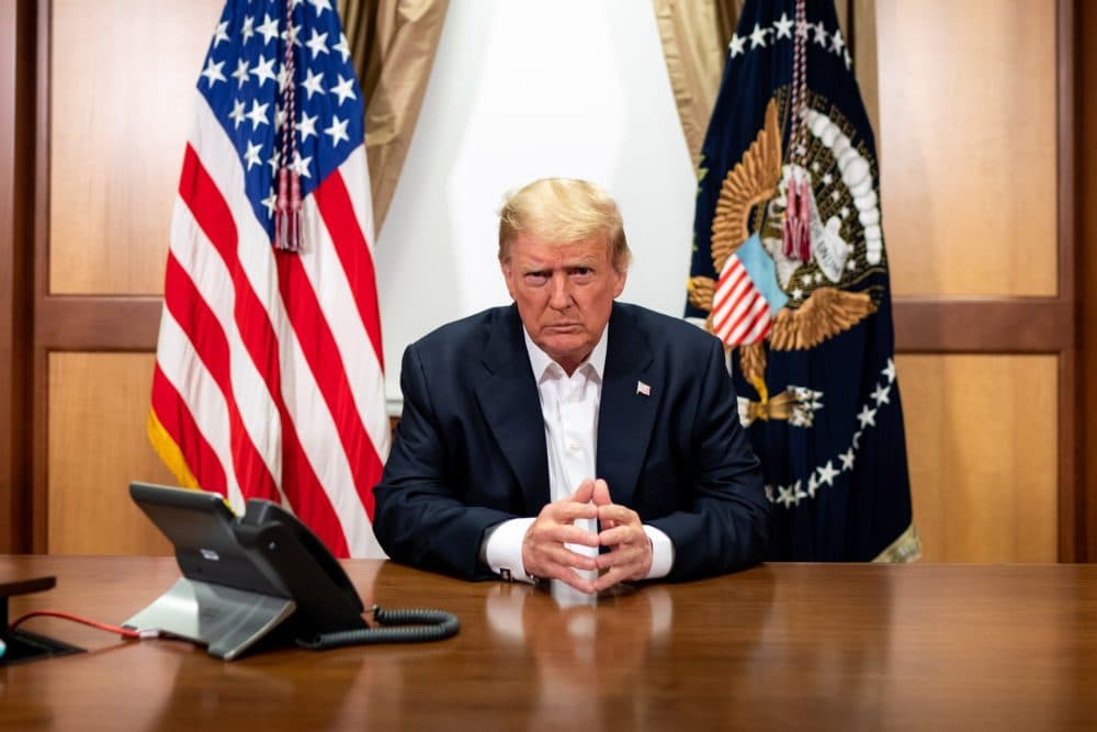 In this handout provided by The White House, President Donald Trump participates in a phone call with Vice President Mike Pence, Secretary of State Mike Pompeo, and Chairman of the Joint Chiefs of Staff Gen. Mark Milley in his conference room at Walter Reed National Military Medical Center on Oct. 4, 2020 in Bethesda, Maryland. (Tia Dufour/The White House via Getty Images)