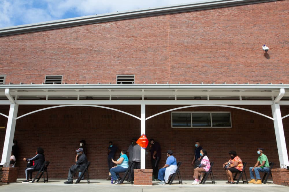 People wait in line on the first day of early voting for the general election at the C.T. Martin Natatorium and Recreation Center on October 12, 2020 in Atlanta, Georgia. (Jessica McGowan/Getty Images)