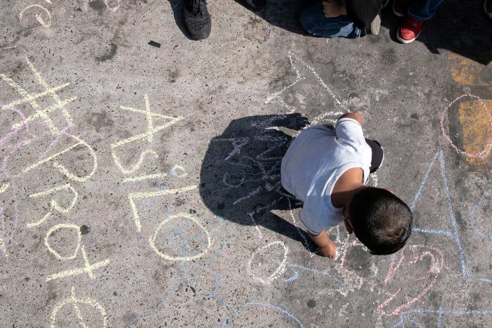 A child takes part in a protest of migrants and human rights activists against U.S. and Mexican migration policies at the San Ysidro crossing port, in Tijuana, Baja California state, Mexico, on the border with the U.S., on October 21, 2020, amid the new coropnavirus pandemic. - With the implementation of the Migrant Protection Protocol (MPP), asylum seekers were forced to remain in Mexico while their migration cases were processed. But, due to the COVID-19 pandemic, U.S. authorities suspended most asylum procedures leaving thousands of migrants stranded along the border. (Photo by Guillermo Arias/ via Getty Images)