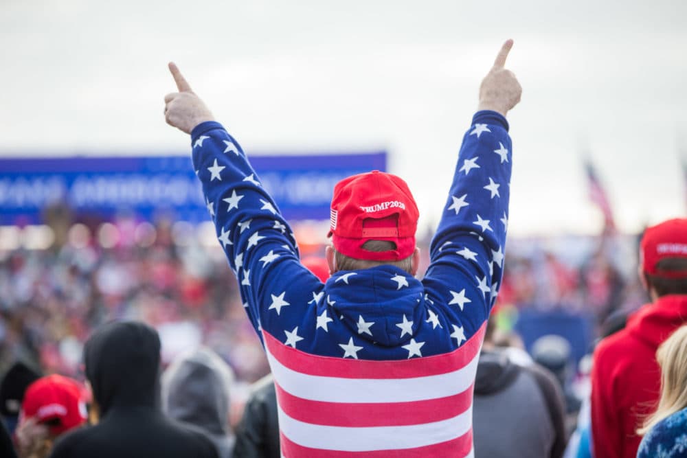 A supporter of President Trump raises his arms during the campaign rally. (Scott Eisen/Getty Images)