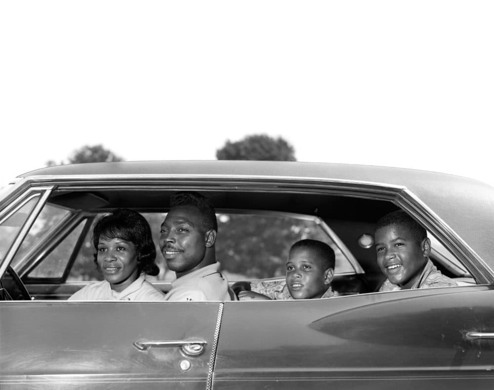 Side view of a family sitting in a four door sedan in the 1960s. (H. Armstrong Roberts/ClassicStock/Getty Images)