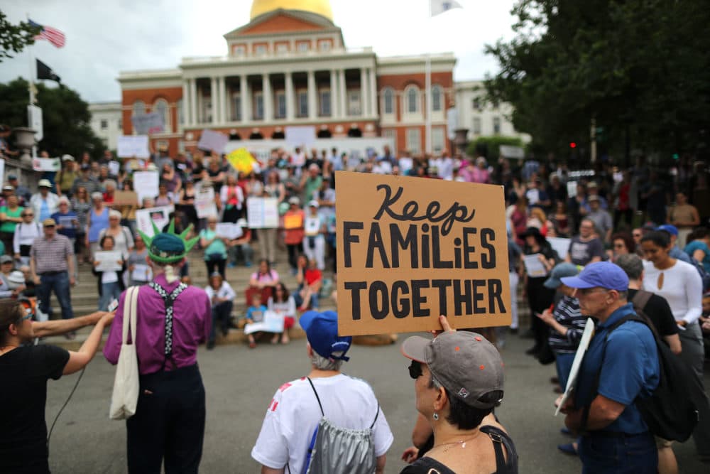 Demonstrators gather outside the Massachusetts State House in Boston to protest the Trump administration policy of separating children from their parents when they arrive at the U.S. border without authorization on June 14, 2018. (John Tlumacki/The Boston Globe via Getty Images)