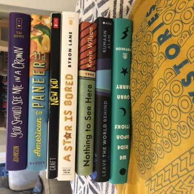 The author's books stacked atop her t-shirt from the book store, Twenty Stories, in Providence, Rhode Island. (Courtesy)